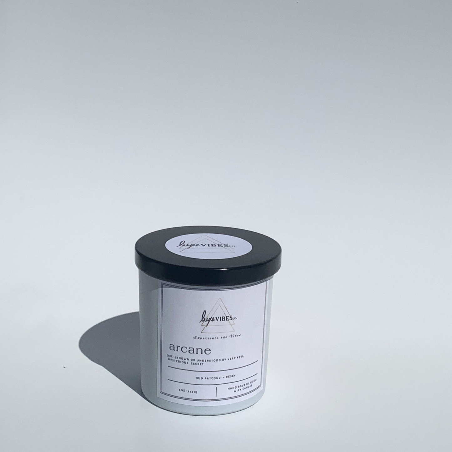 Arcane scented candle;  white jar with black lid